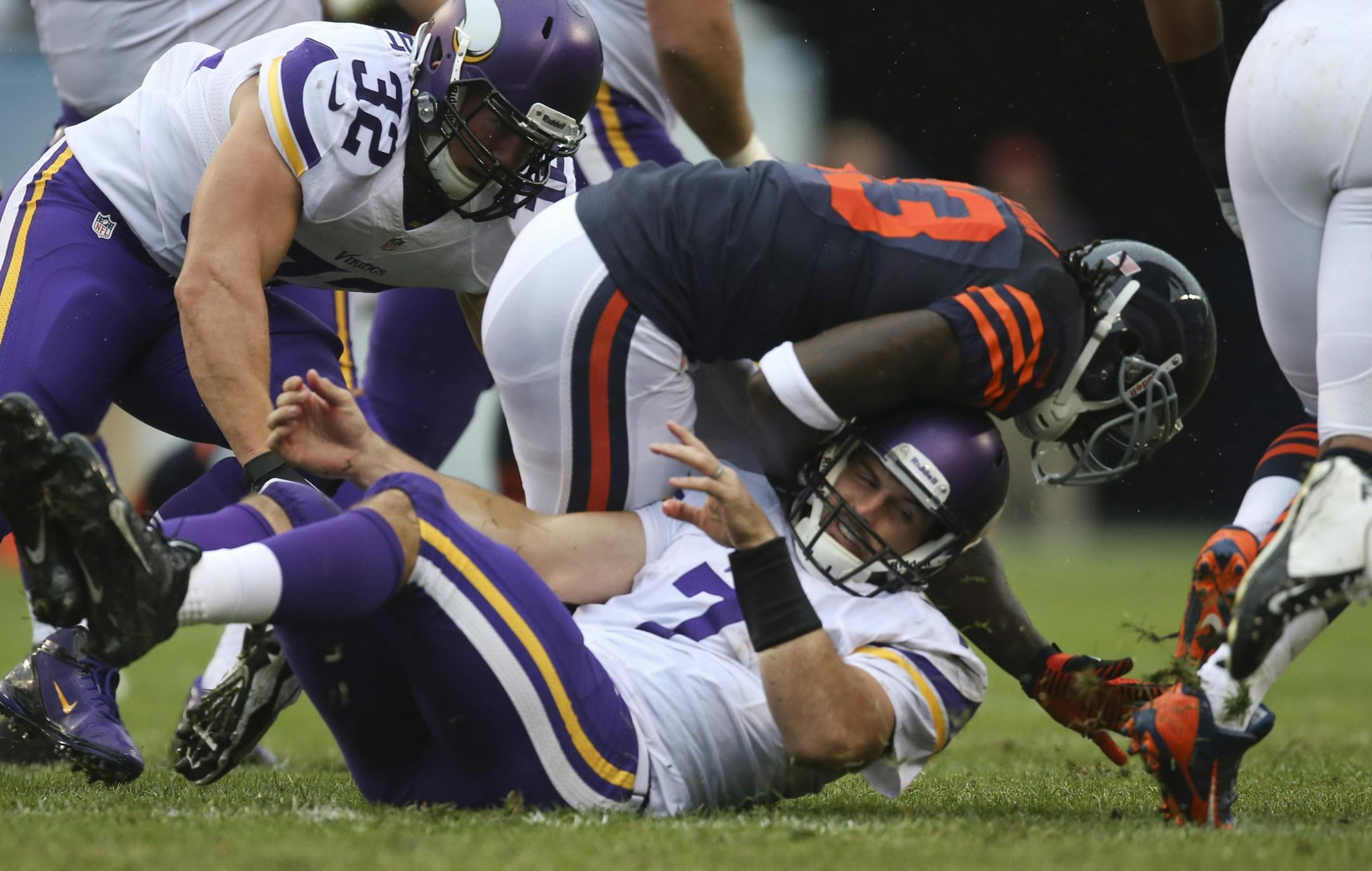 The Minnesota Vikings lost to the Chicago Bears 31-30 at Soldier Field in Chicago on a rainy Sunday afternoon, September 15, 2013. Minnesota Vikings quarterback Christian Ponder (7) was knocked to the ground by Chicago Bears cornerback Charles Tillman (33) in the first quarter.