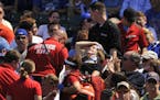 A fan is carried away after being hit a by a line-drive foul ball during the first inning of a baseball game between the Chicago Cubs and the Atlanta 