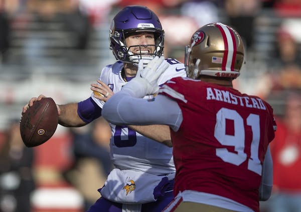 Kirk Cousins was pressured by San Francisco 49ers defensive end Arik Armstead before he sacked Cousins during the second quarter.