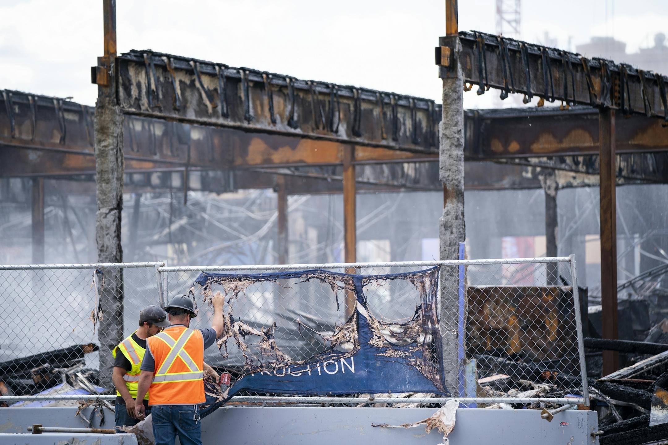 Construction workers watched as St. Paul firefighters battled a fire at a construction site across from Xcel Energy Center in downtown St. Paul.