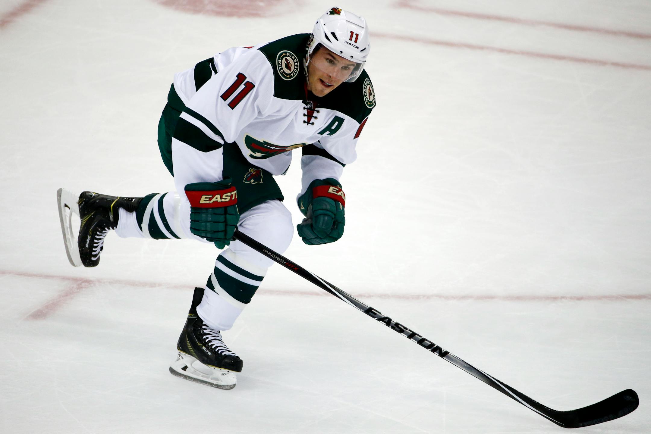 Minnesota Wild's Zach Parise (11) skates in the first period of a NHL pre-season hockey game against the Pittsburgh Penguins in Pittsburgh Thursday, Sept. 25, 2014. (AP Photo/Gene J. Puskar)