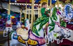 Eliah Goodwin,4, got to enjoy the carousel by himself on a school night.] The State Fair at night is an interesting place and different animal from th