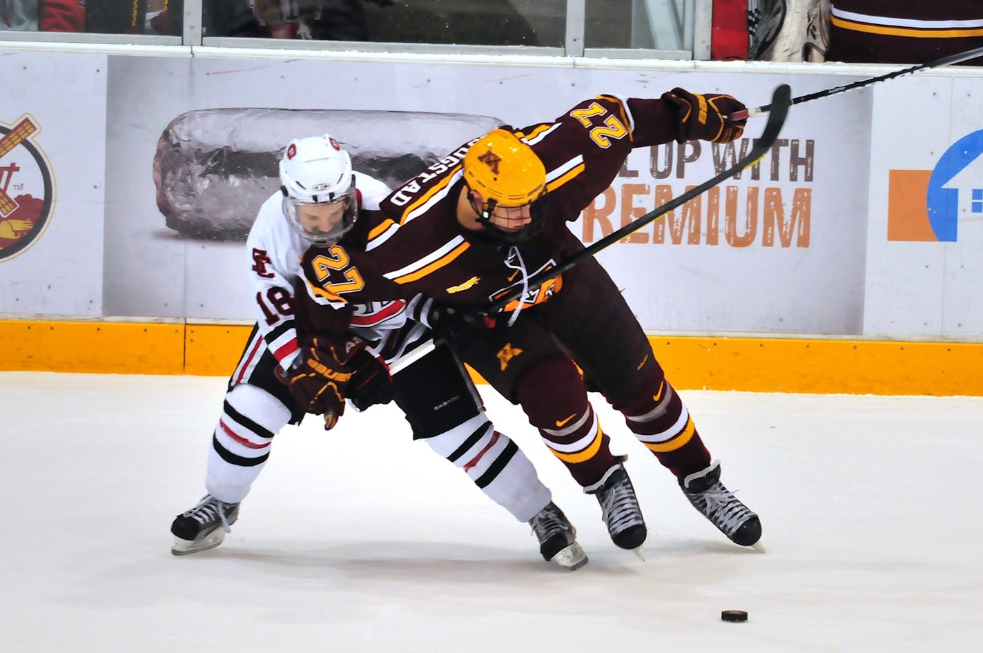 Minnesota's Nick Bjustad (27) brings the puck up against St. Cloud's Garrett Milan during the second period at the National Hockey Center in St. Cloud Saturday, January 28. Photo by Bre McGee.