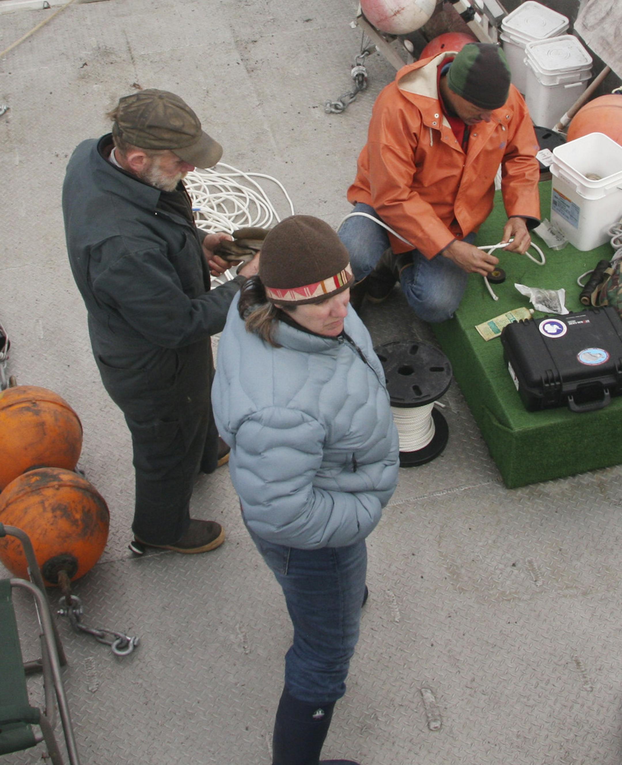 In this May 14, 2009 photo provided by the University of Alaska Fairbanks, a research crew and a boat crewman prepare to deploy a hydrophone to record underwater sound in Icy Bay, Alaska. Glaciologist Erin Pettit began a research project to find out what calving glacier ice sounded like to a humpback whale. The sound of the ice in the water turned out to be more interesting. Acoustic research in Alaska’s Icy Bay and other glacier ice-filled waters found that the fizz created by the releas