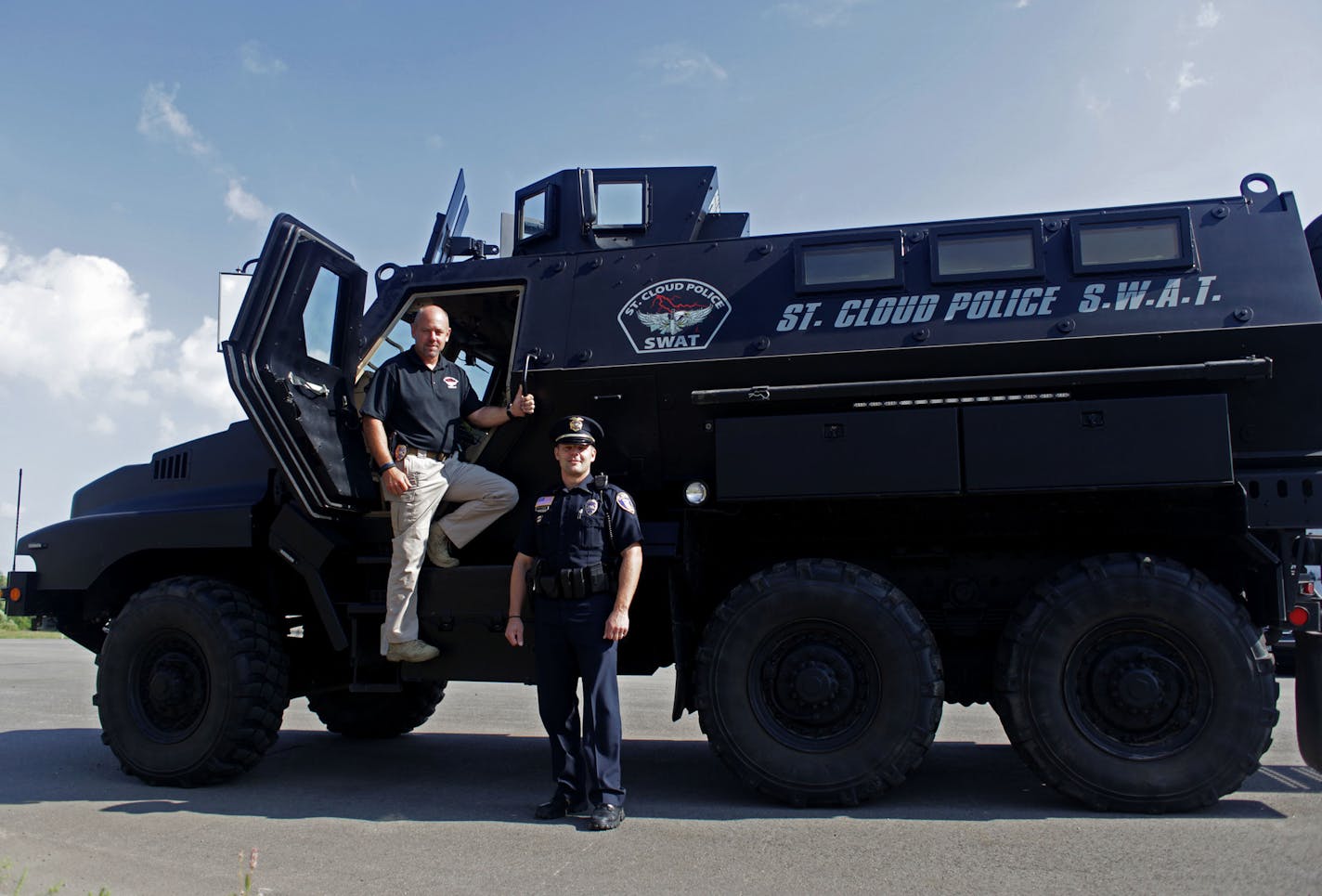 Sgt. Martin Sayre and Lt. Jeff Oxton, of the St. Cloud police department SWAT team and their Mine Resistant Ambush Protected vehicle (MRAP), that was previously used in Afghanistan.