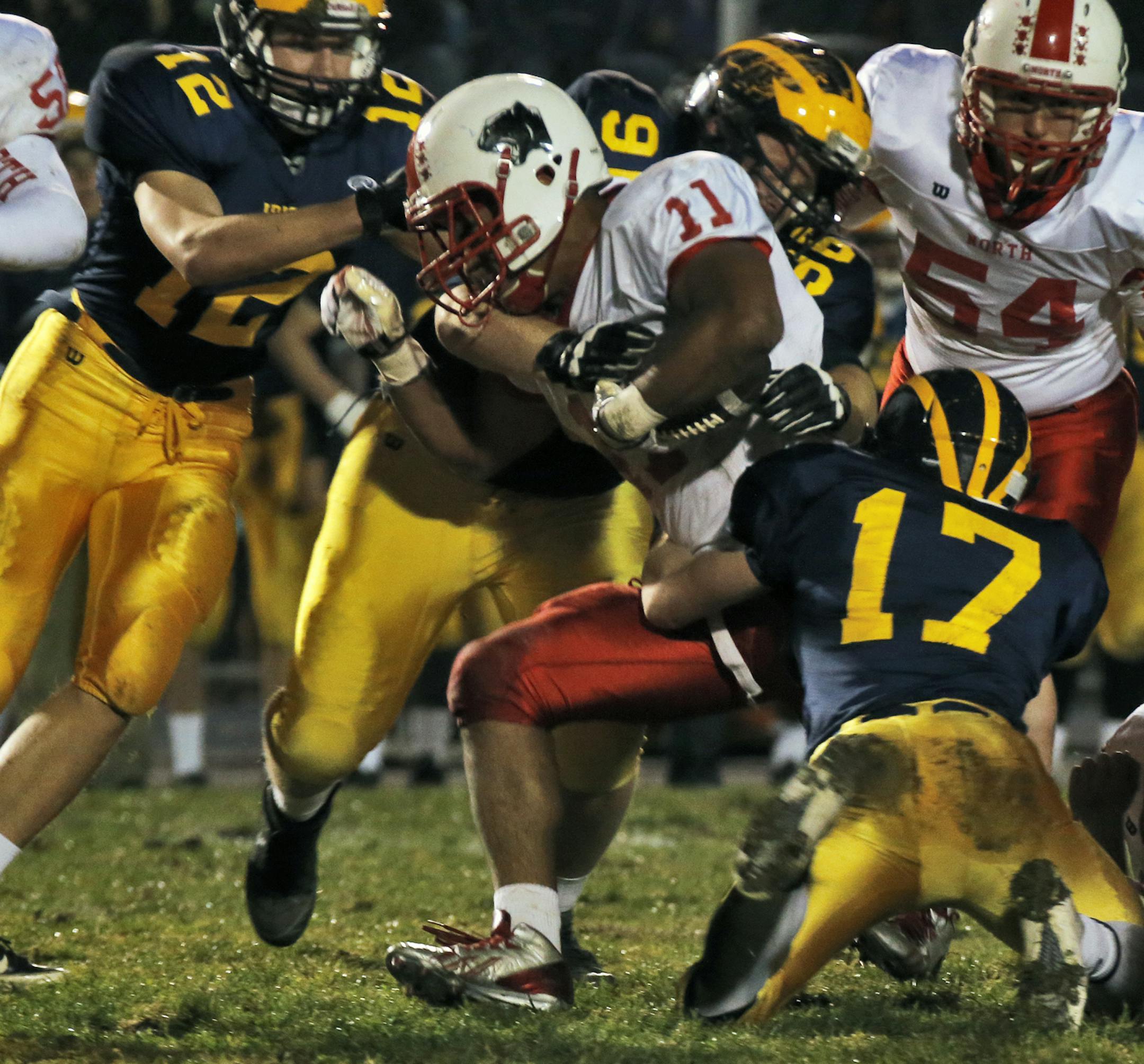 Rosemount vs. Lakeville North prep football. Rosemount defenders including Ryan Fox (17) held Lakeville North running back Gregory Menard (11) to no gain on a first half rushing play. . (MARLIN LEVISON/STARTRIBUNE(mlevison@startribune.com) ORG XMIT: MIN1310162047217309