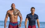 This image released by Paramount Pictures shows Dwayne Johnson as Mitch Buchannon, left, and Zac Efron as Matt Brody in "Baywatch." (Frank Masi/Paramo