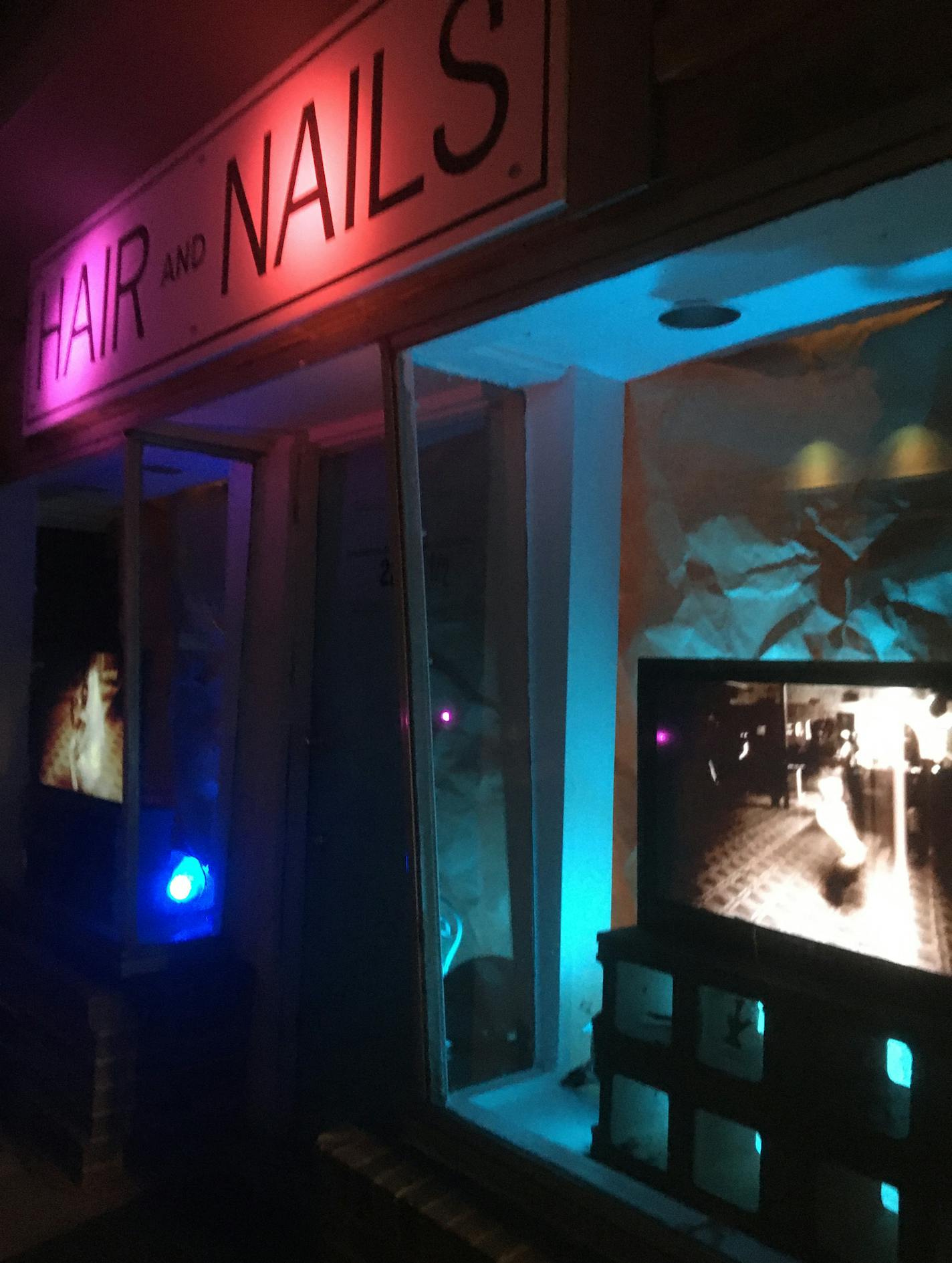 Hair & Nails Gallery in south Minneapolis recently opened "Holding Space," a video exhibit that utilized their street-facing windows. Photo by Kristin Van Loon