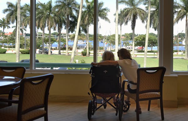 Jana Panarites with her mother, Helen, at her assisted-living facility in West Palm Beach, Fla., July 13, 2016. While caring for her mother, Panarites