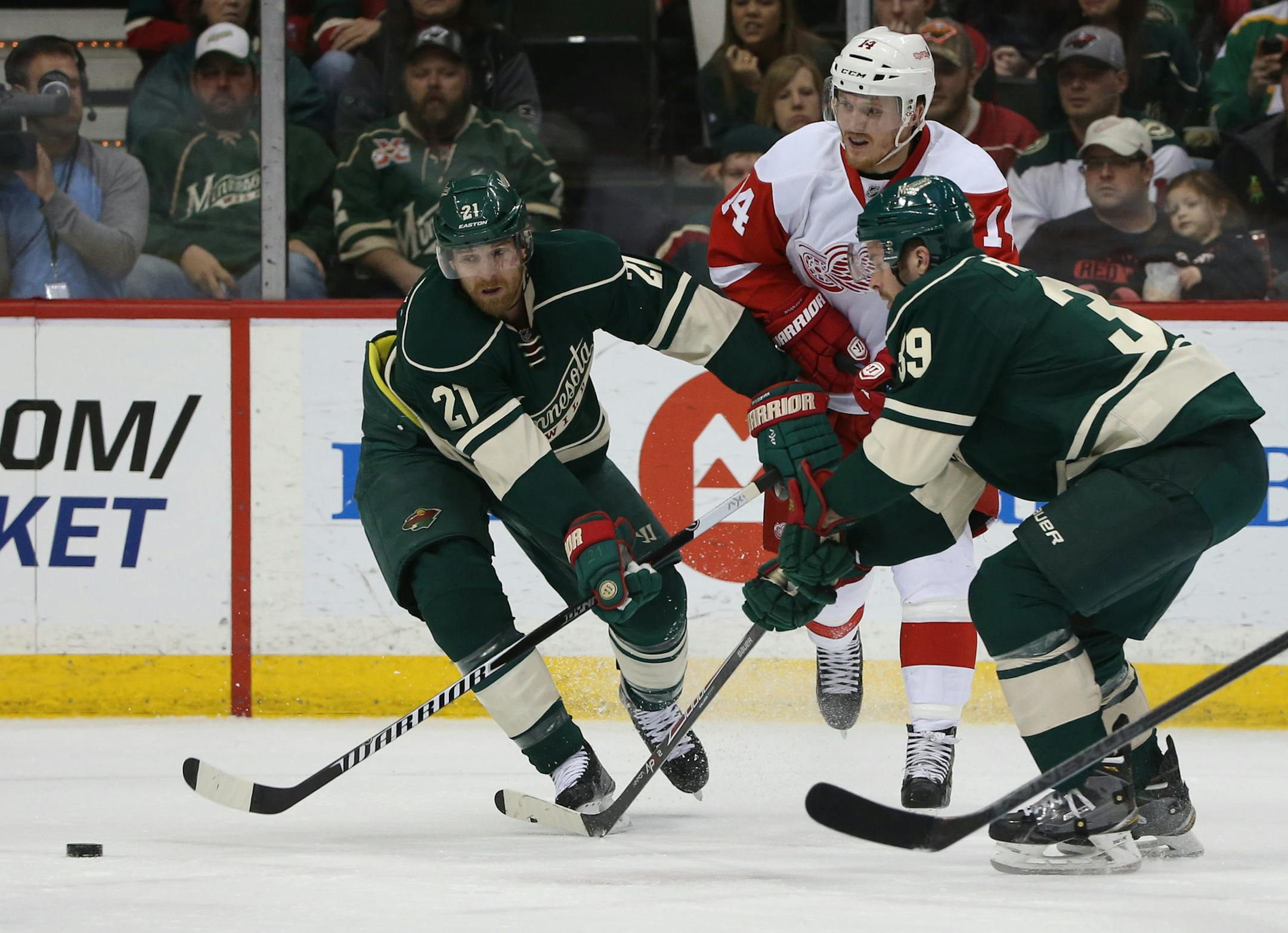 The Wild Kyle Brodziak and Nate Prosser boxed out Red Wing's Gustav Nyqvist for the puck during the first period. ] (KYNDELL HARKNESS/STAR TRIBUNE) kyndell.harkness@startribune.com Wild ve Red Wings at the Xcel Energy Center in St. Paul Min., Saturday, April 4, 2014.
