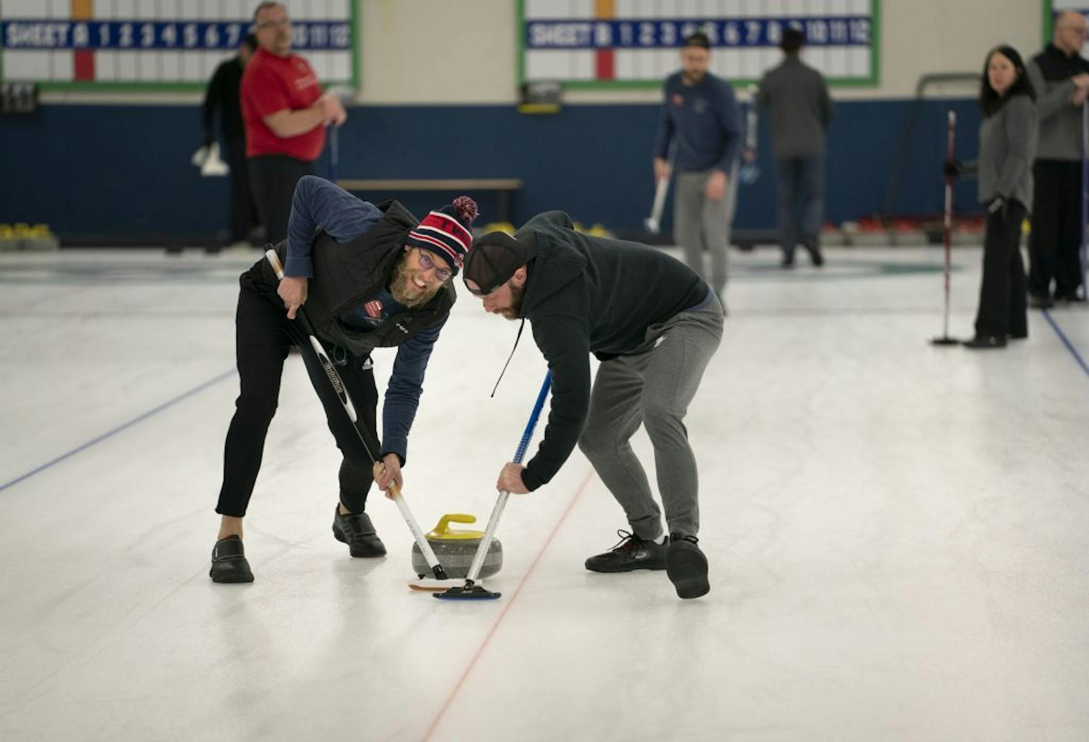 Brad Schwantke and Derek Doty swept in front of the stone during their curling league at the Four Seasons Curling Club in Blaine, Minn., Wednesday, January 29, 2020.