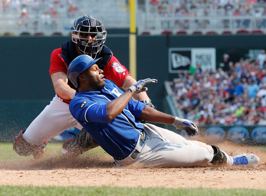 Twins catcher Chris Gimenez tagged out the Royals' Lorenzo Cain