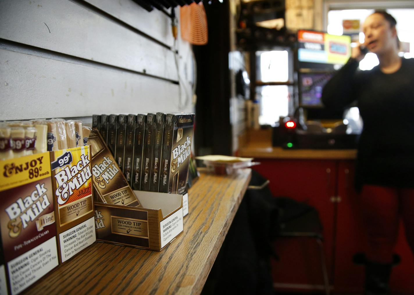 Cashier Tanise Schaumburg answered a phone call at the Highland Service Station in St. Paul. ] CARLOS GONZALEZ cgonzalez@startribune.com - January 6, 2016, St. Paul, MN, St. Paul will vote Wednesday on whether to ban the sale of flavored tobacco products in the city with the exception of specialty stores that only serve customers older than 18. If the council approves the change, it will follow the lead of Minneapolis and other cities