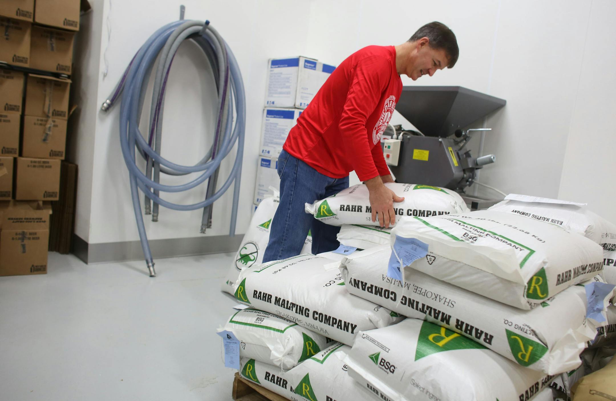 Bob DeLange, of Waconia Brewery Company, separated out bags of malt for an amber beer they were going to brew the next day ] (KYNDELL HARKNESS/STAR TRIBUNE) kyndell.harkness@startribune.com Visit to J Caver Distillery and Waconia Brewery Company in Waconia , Min., Wednesday, November 12, 2014.