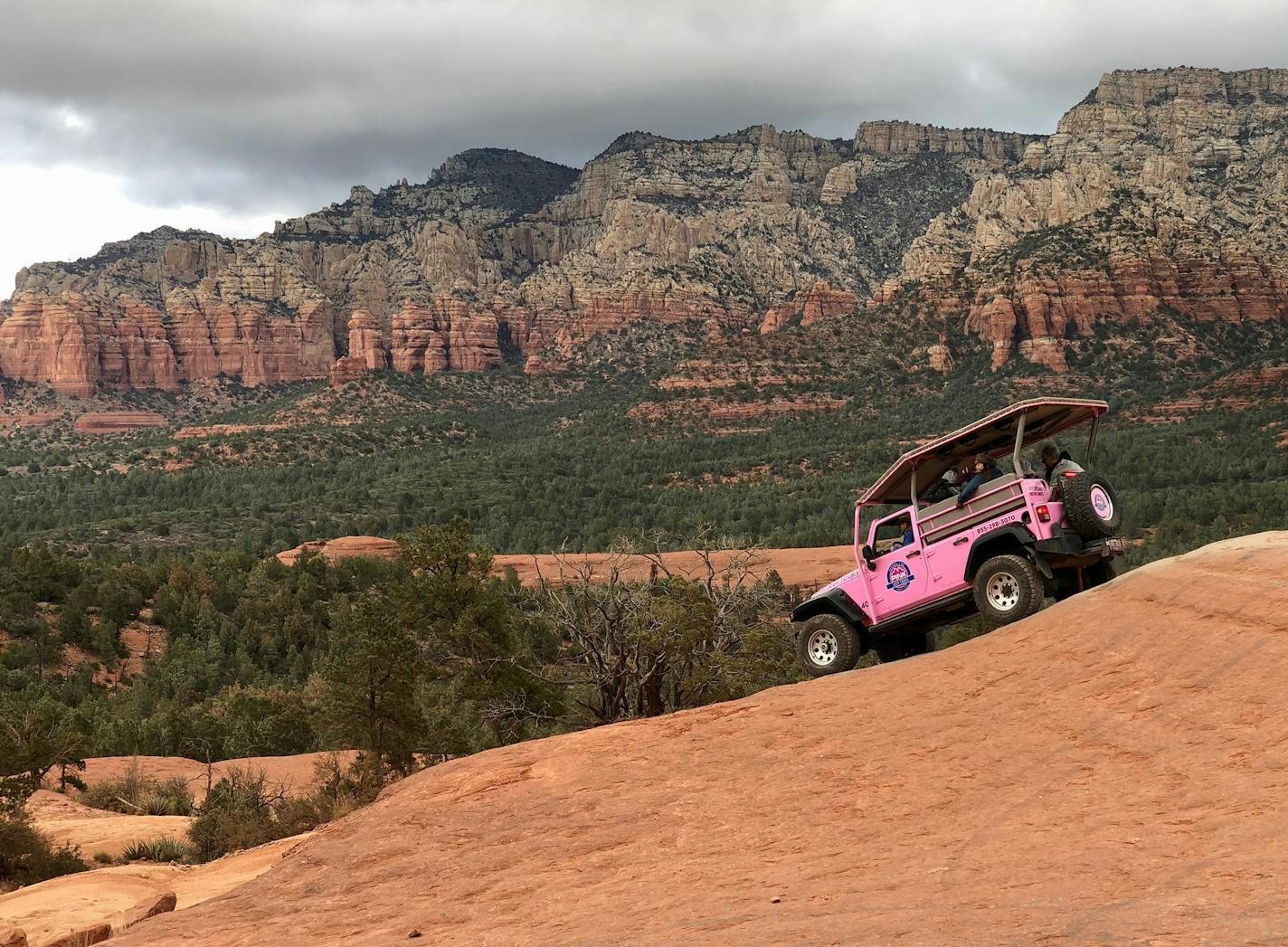 The Pink Jeep "Broken Arrow" tour begins its descent down the red rocks in Coconino National Forest.