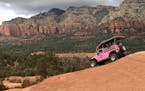 The Pink Jeep "Broken Arrow" tour begins its descent down the red rocks in Coconino National Forest.