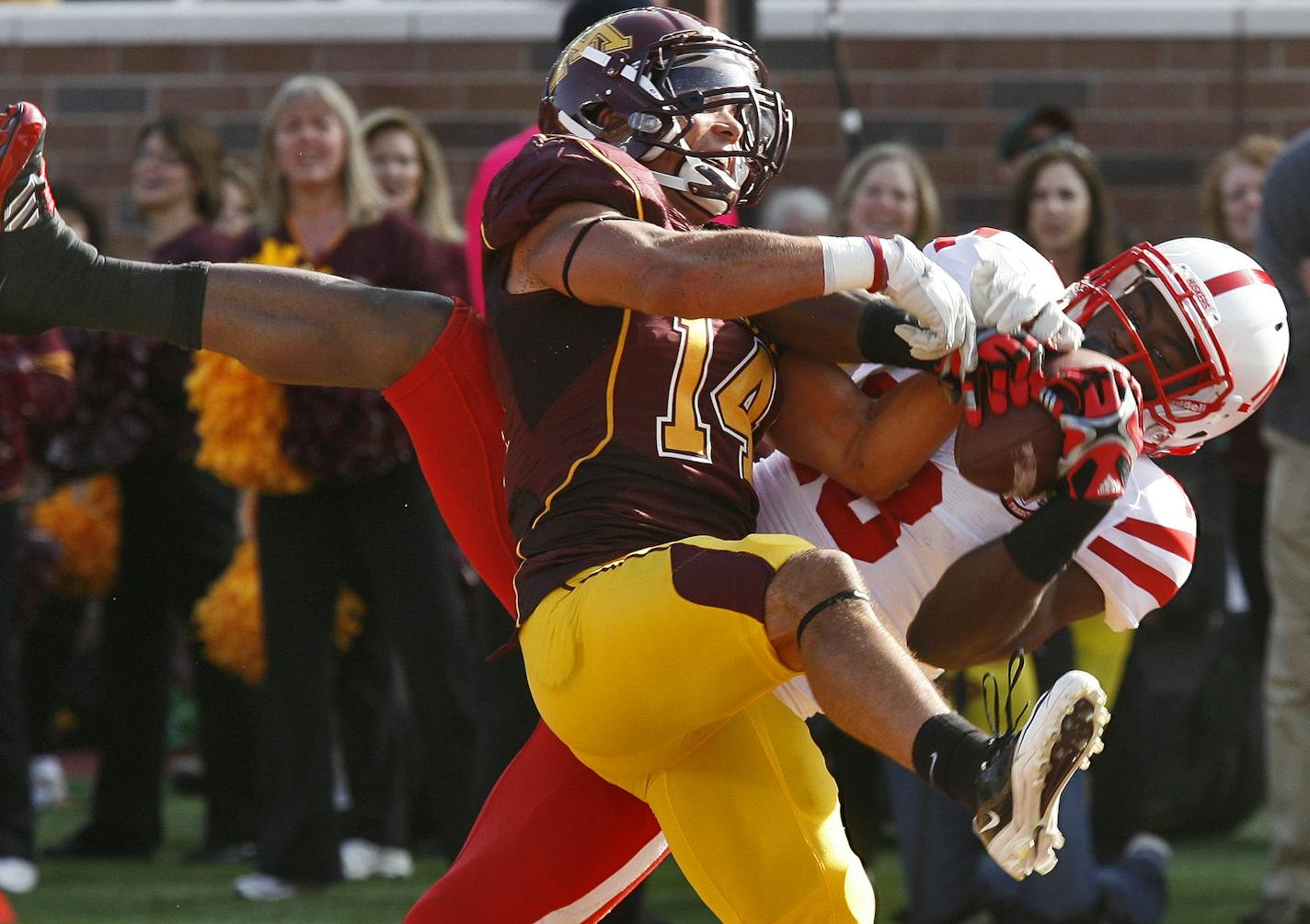 Minnesota Gophers football vs. Nebraska Cornhuskers. Minnesota's defense played well at times in spite of the final score. Here Gophers defender Kyle Henderson (14) broke up a first half pass in the end zone intended for Nebraska receiver Quincy Enunwa.