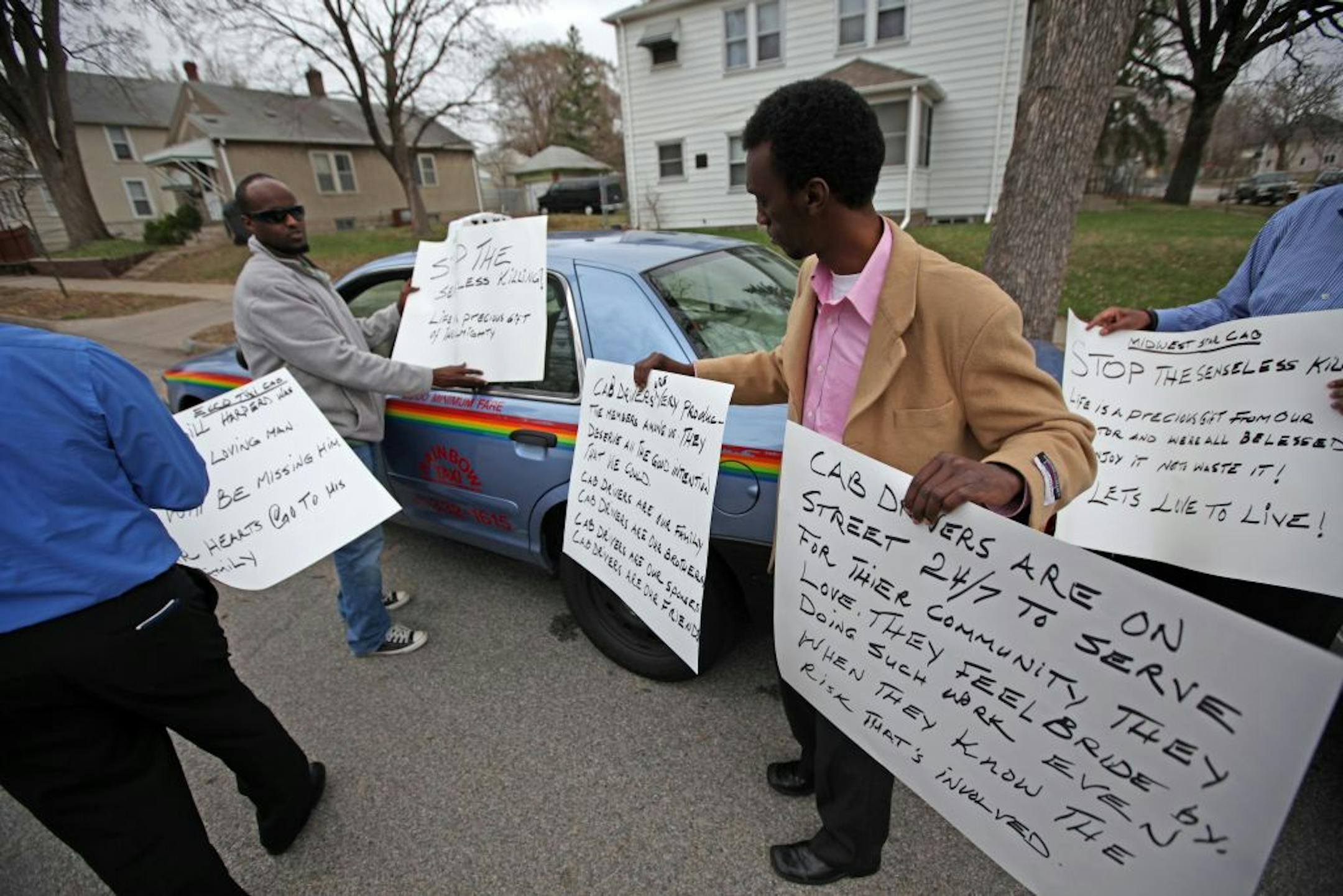 Cabdrivers gathered Wednesday afternoon in north Minneapolis at the site of the recent killing of colleague William Harper, voicing concerns and showing support for the Harper family. From left were Yemane Mebrahtu, Hanad Fodey, Iid Ali and Mohamed Egal.