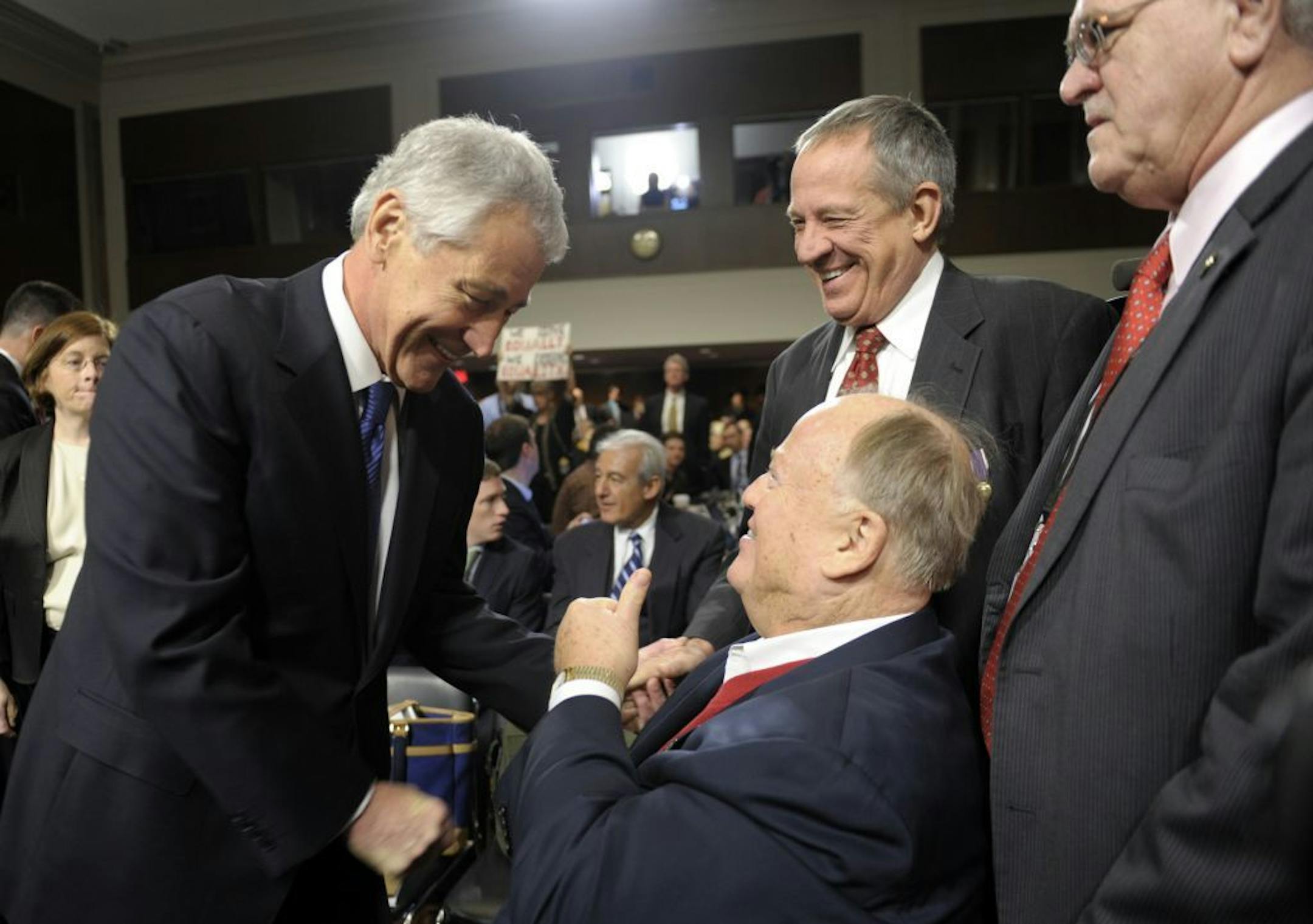 Former Nebraska Republican Sen. Chuck Hagel, left, President Barack Obama's choice for defense secretary, greets former Georgia Sen. Max Cleland, center, after arriving on Capitol Hill in Washington, Thursday, Jan. 31, 2013, to testify before the Senate Armed Services Committee hearing on his nomination.