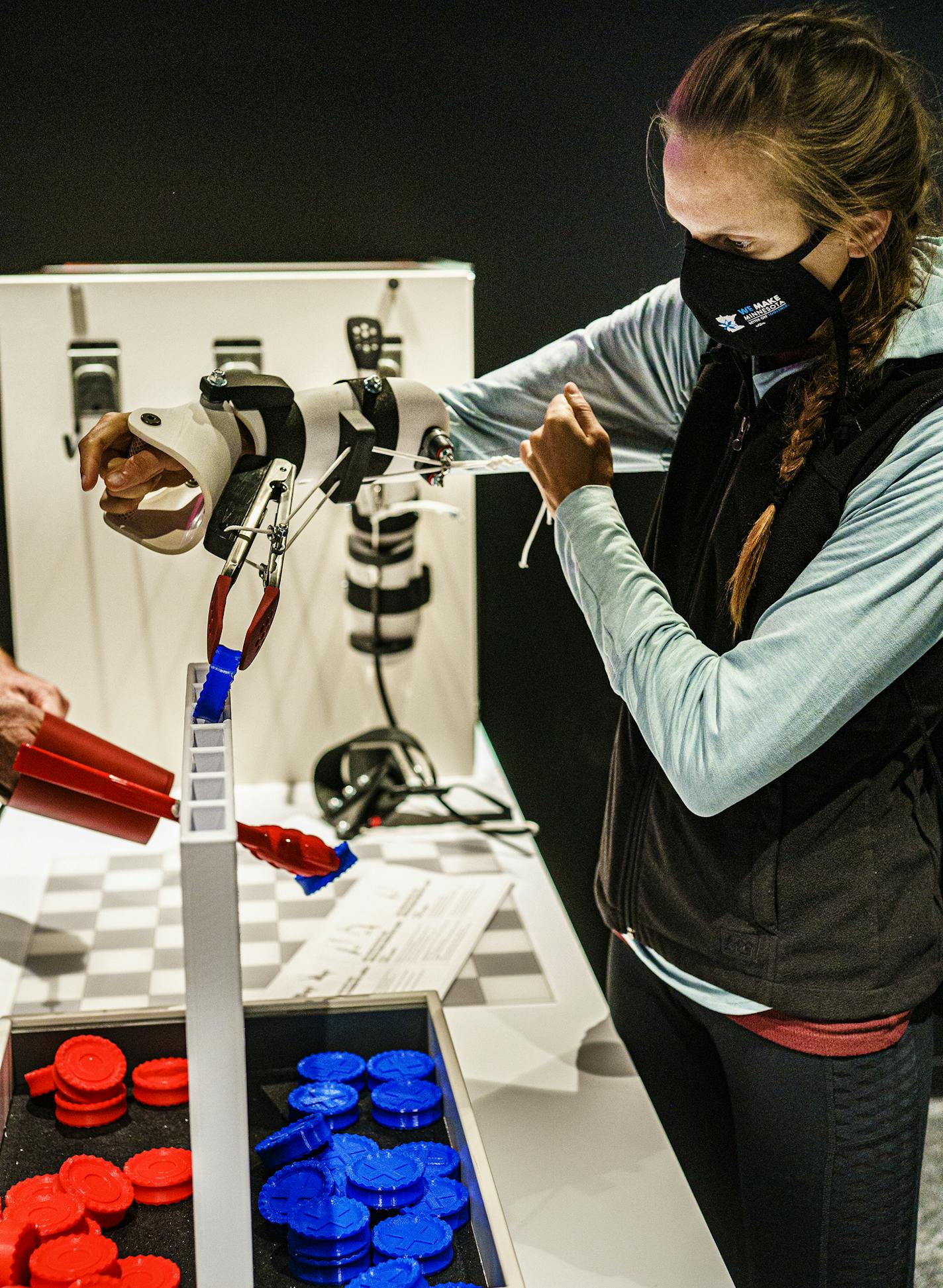 Emily Minge played Connect Four with a prosthetic arm to experience what it feels like to use one.