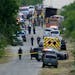 Police work the scene where dozens of people were found dead in a semitrailer in a remote area in southwestern San Antonio, Monday, June 27, 2022. (AP