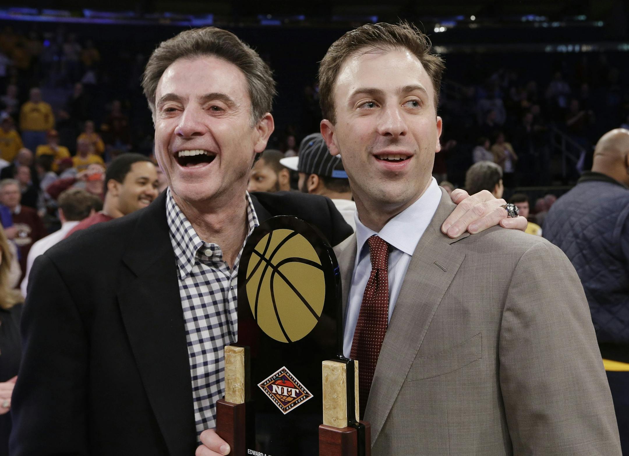 Minnesota coach Richard Pitino, right, stands with his father, Rick Pitino, after Minnesota's 65-63 win over SMU in an NCAA college basketball game in the final of the NIT on April 3, 2014, in New York.