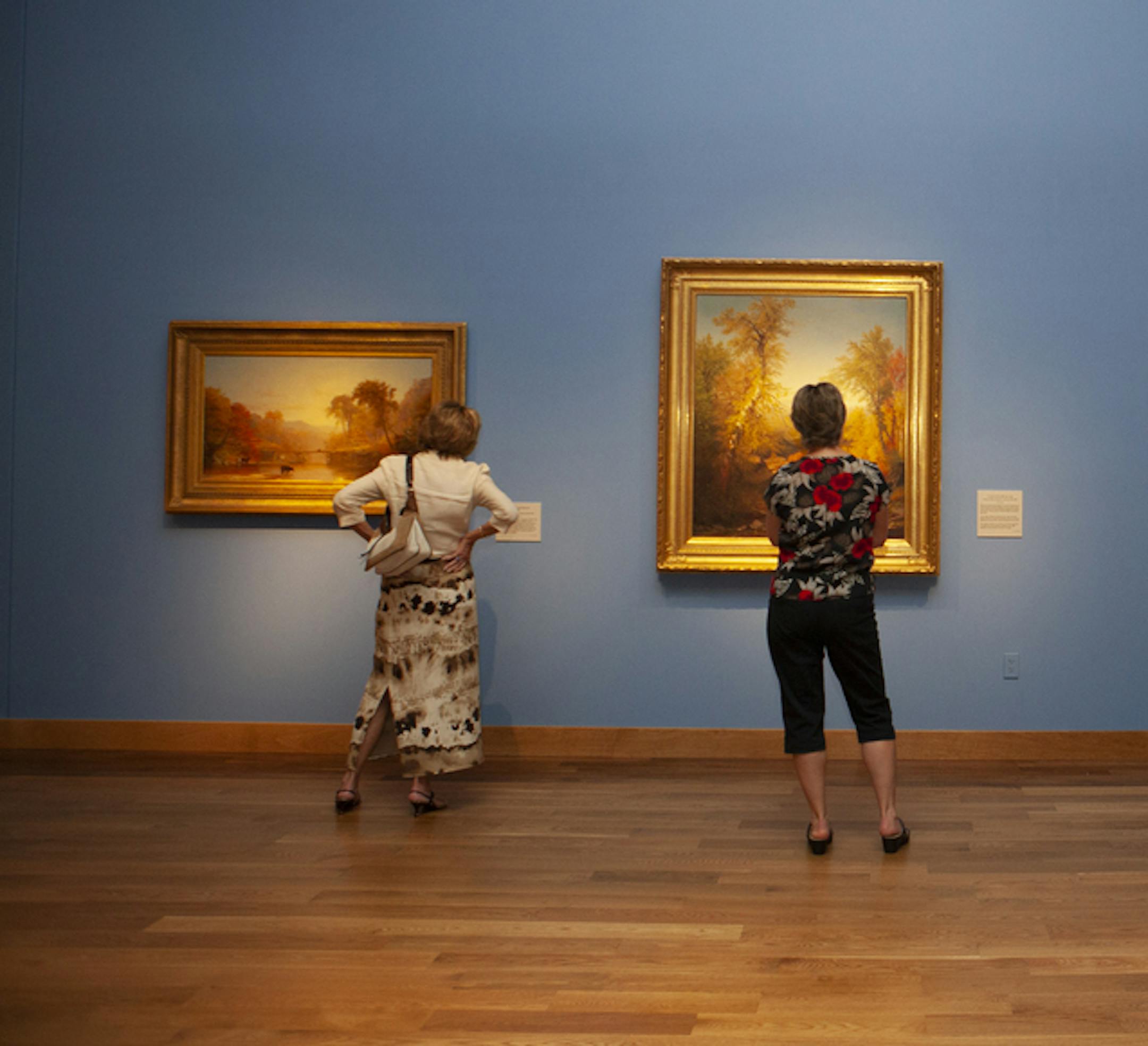People view the Hudson River School collection at the Minnesota Marine Art Museum in Winona, Minnesota on Sept. 27, 2014. In addition to collections that include Monet, Picasso, Van Gogh, O'Keefe, and many other internationally acclaimed artists, the Minnesota Marine Art Museum has one of the best collections of Hudson River School art in the world. (Cynthya Porter/Visit Winona)