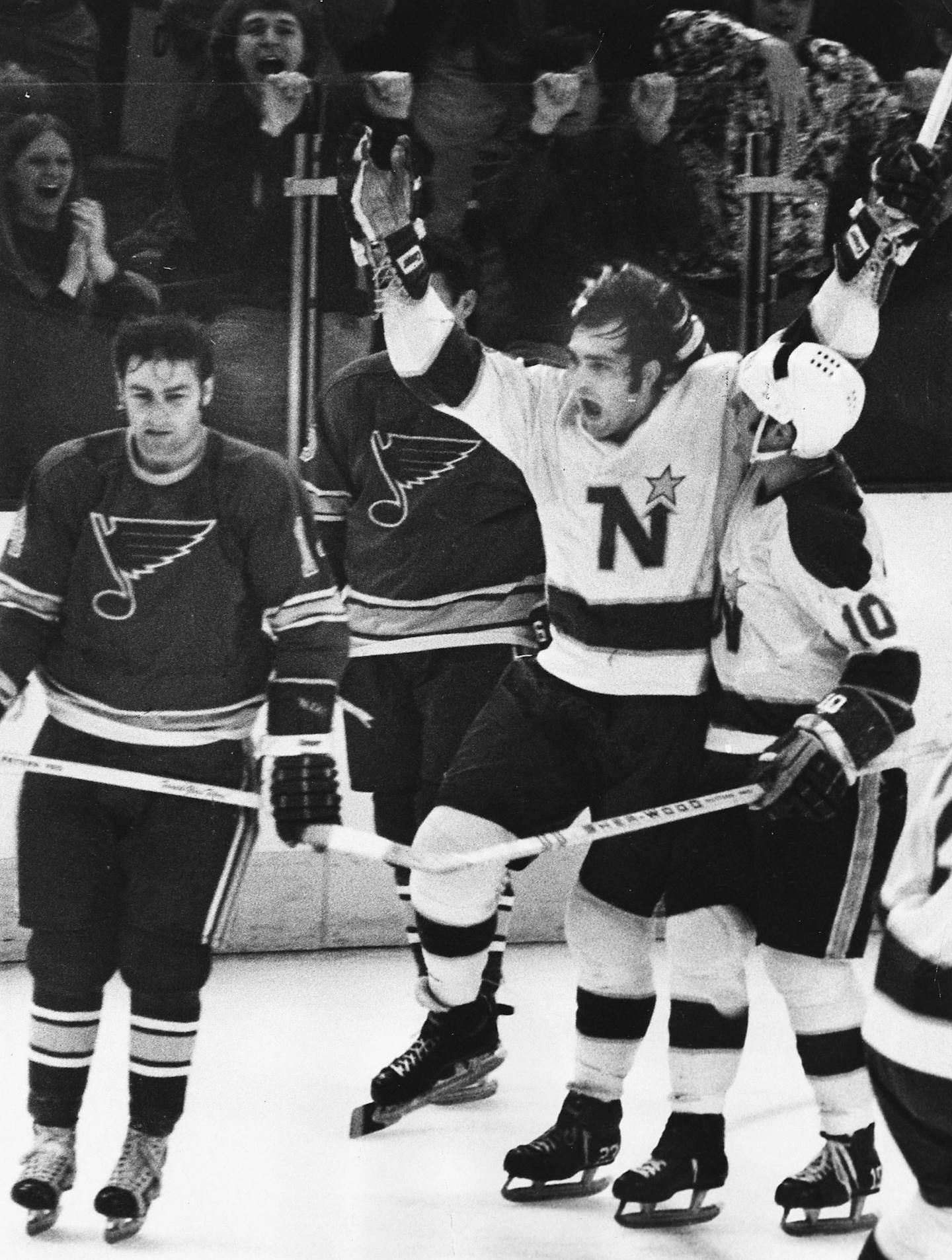 North Star Lou Nanne jumped for joy after giving his team a 2-1 lead in the second period. Hugging Nanne was Murray Oliver whose pass set up the goal. (1971)