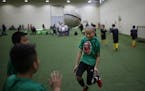 Kenji Moua (center) of the Generation X soccer team warmed up with his 11u/12u team game at the National Sports Center Sunday February 19, 2017 in Bla
