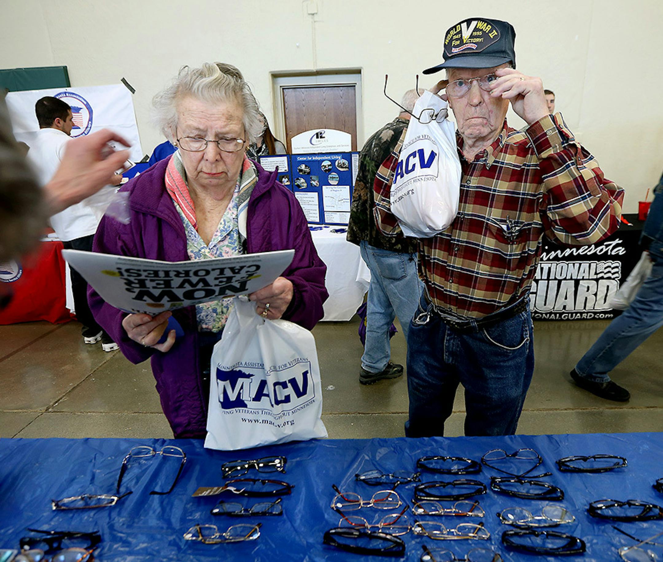 Sylvia and Marvin Allen, 89, a Naval WWII veteran, tested several pairs of glasses before picking the right fit, at the Standdown for Veterans event at the Mankato National Guard Armory, Tuesday, November 10, 2015 in Mankato, MN.