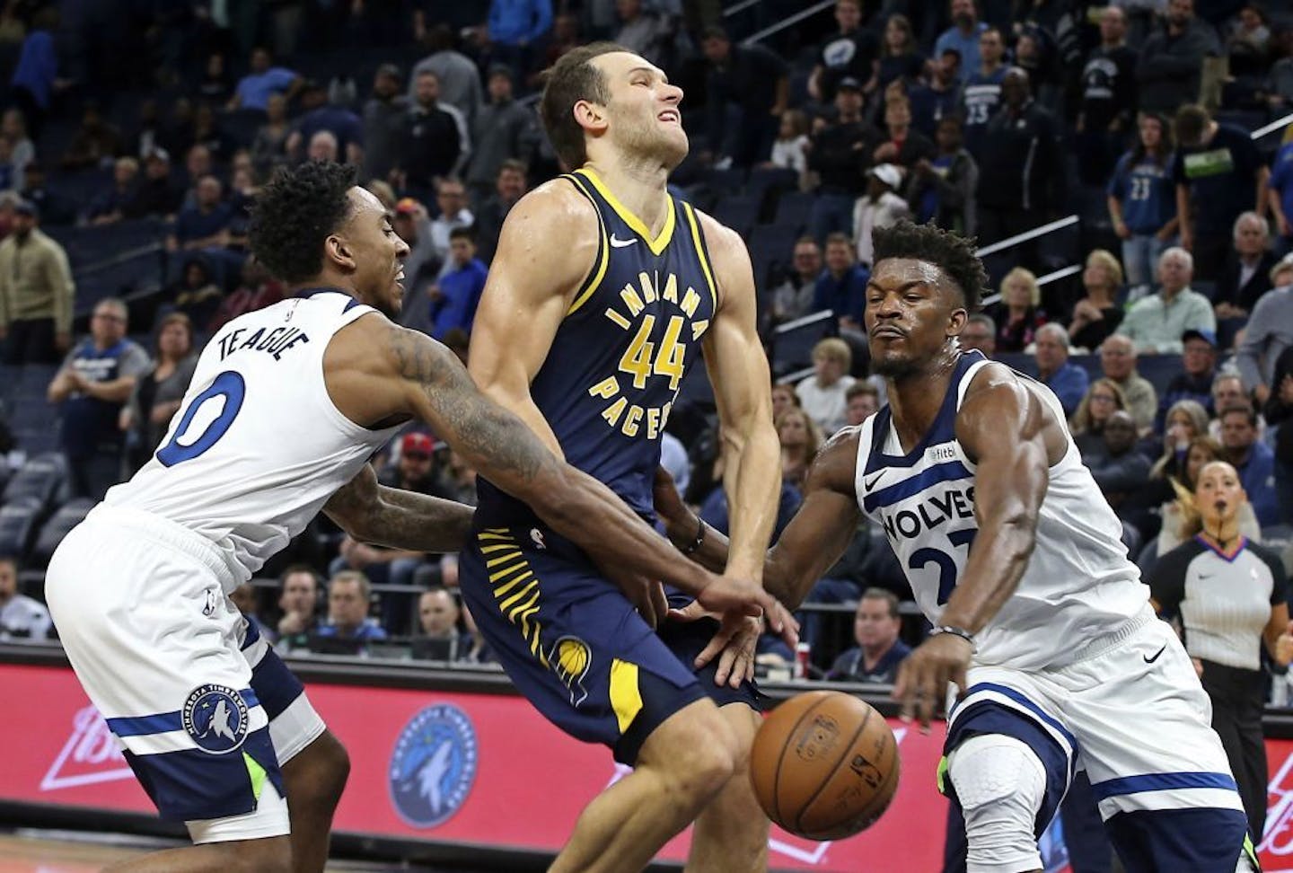 Minnesota Timberwolves' Jeff Teague, left, and Jimmy Butler, right, break up a drive by Indiana Pacers' Bojan Bogdanovic, of Croatia, in the second half of an NBA basketball game, Monday, Oct. 22, 2018, in Minneapolis. The Timberwolves won 101-91.