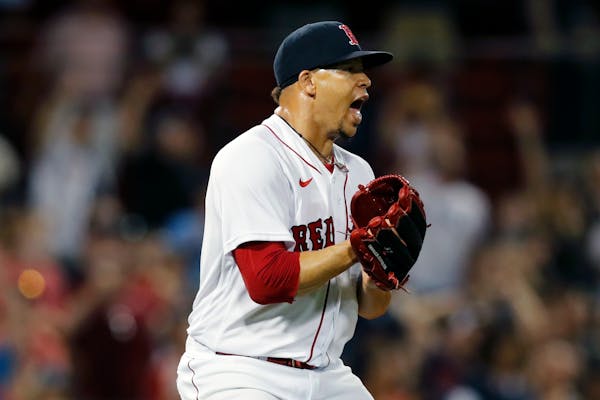 Hansel Robles reacts after Jake Cave made the final out of Boston’s 11-9 victory over the Twins.