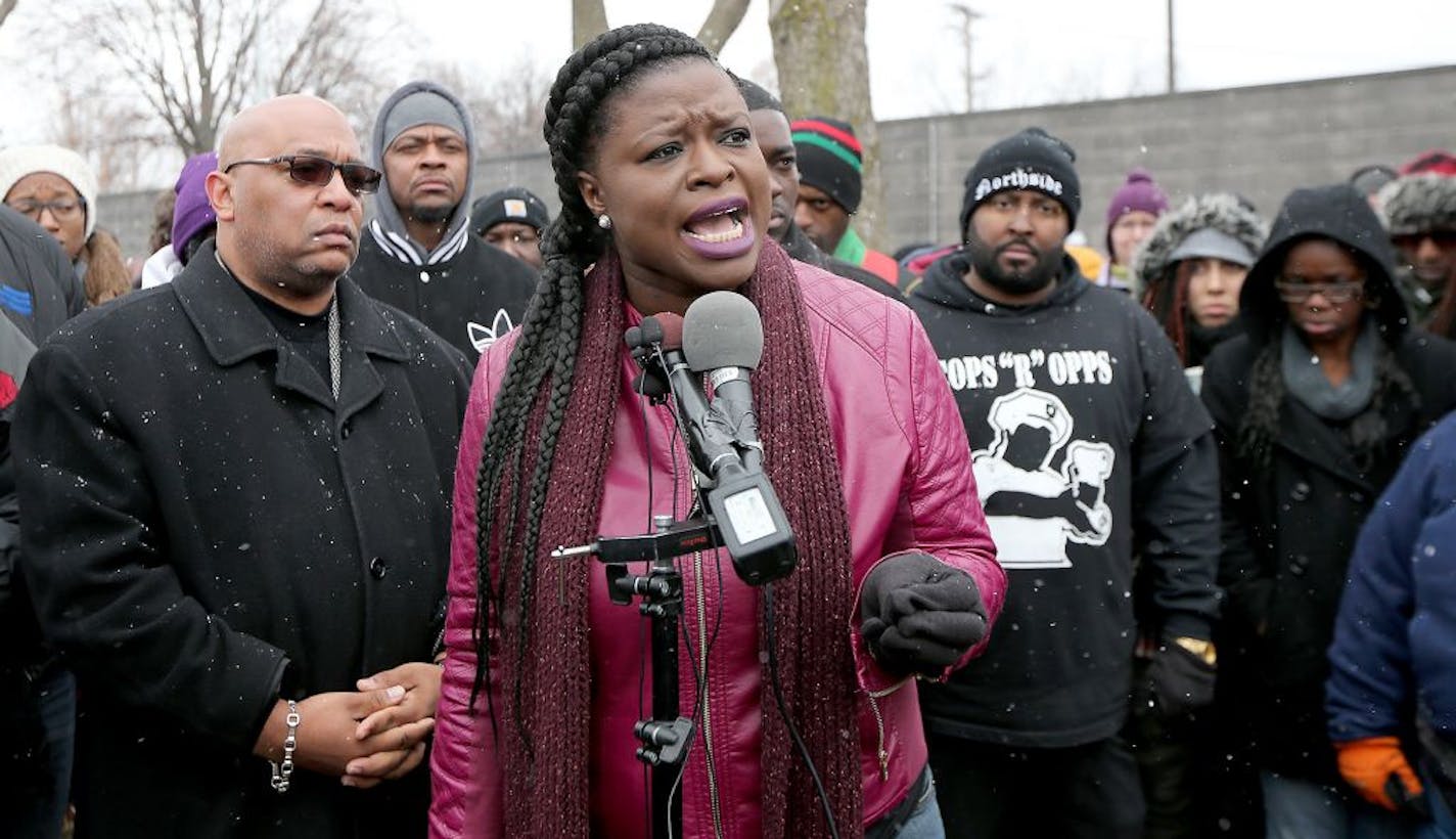 Standing before other protestors, Minneapolis NAACP President Nekima Levy-Pounds spoke to the press demanding that the police release the video of Jamar Clark's shooting, outside the Fourth Police Precinct, Wednesday, November 4, 2015 in Minneapolis, MN.