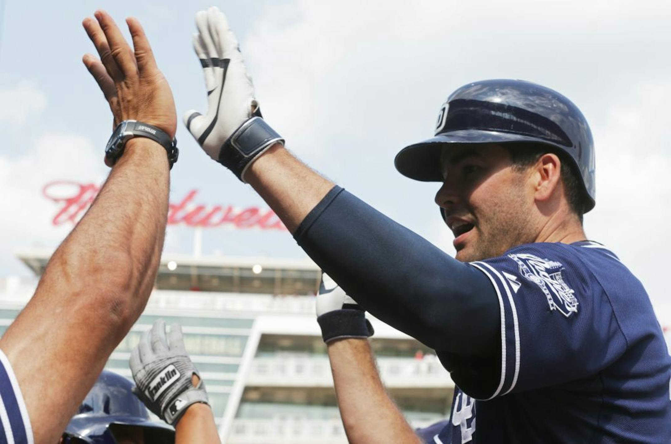 San Diego Padres' Seth Smith is welcomed in the dugout after his go-ahead solo home run off Twins relief pitcher Anthony Swarzak in the 10th inning Wednesday.
