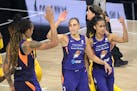 Phoenix Mercury guard Diana Taurasi (3) is congratulated by center Brittney Griner, left, and Skylar Diggins-Smith (4) after scoring a basket during t