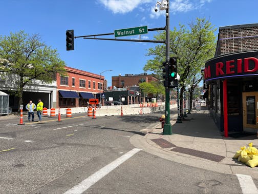 Crews stand along West Seventh Street in St. Paul, where a sinkhole opened. Construction could shut down regular traffic to the area for months.
