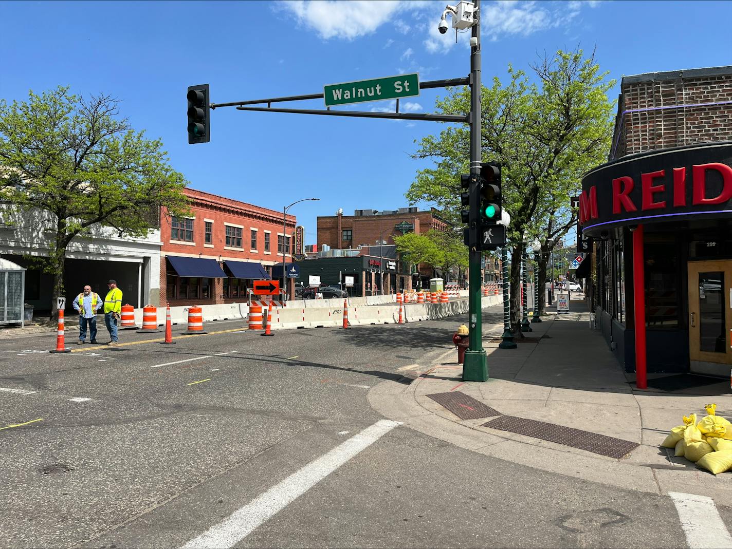 Crews stand along West Seventh Street in St. Paul, where a sinkhole opened. Construction could shut down regular traffic to the area for months.