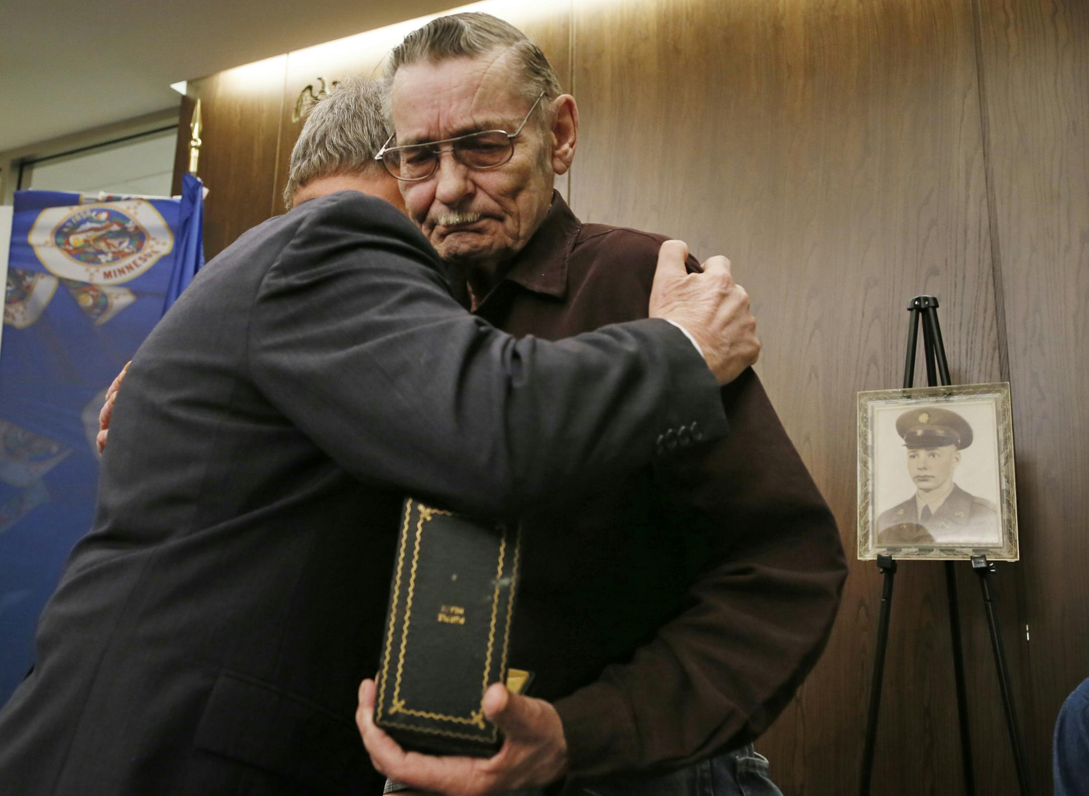 Minnesota Department of veterans Affairs Commissioner Larry Shellito left hugged William Johnson after giving him back the purple heart medal that his deceased brother, Korean War Veteran George J. Johnson earned. Commissioner Shellito presented the medal to family members during a ceremony Wednesday January 29, 2014 in St. Paul ,MN.] George Johnson died July 28, 1950 in the Battle of Hwanggan, his parents were presented the with a Bronze Star, Medal and Purple Heart medal for his bravery . The