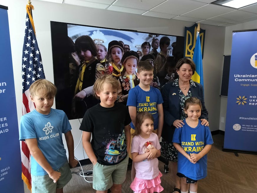 U.S. Sen. Amy Klobuchar poses for a photo with Ukrainian children during an event at the Ukrainian American Community Center in Minneapolis, Sunday, July 13, 2025.