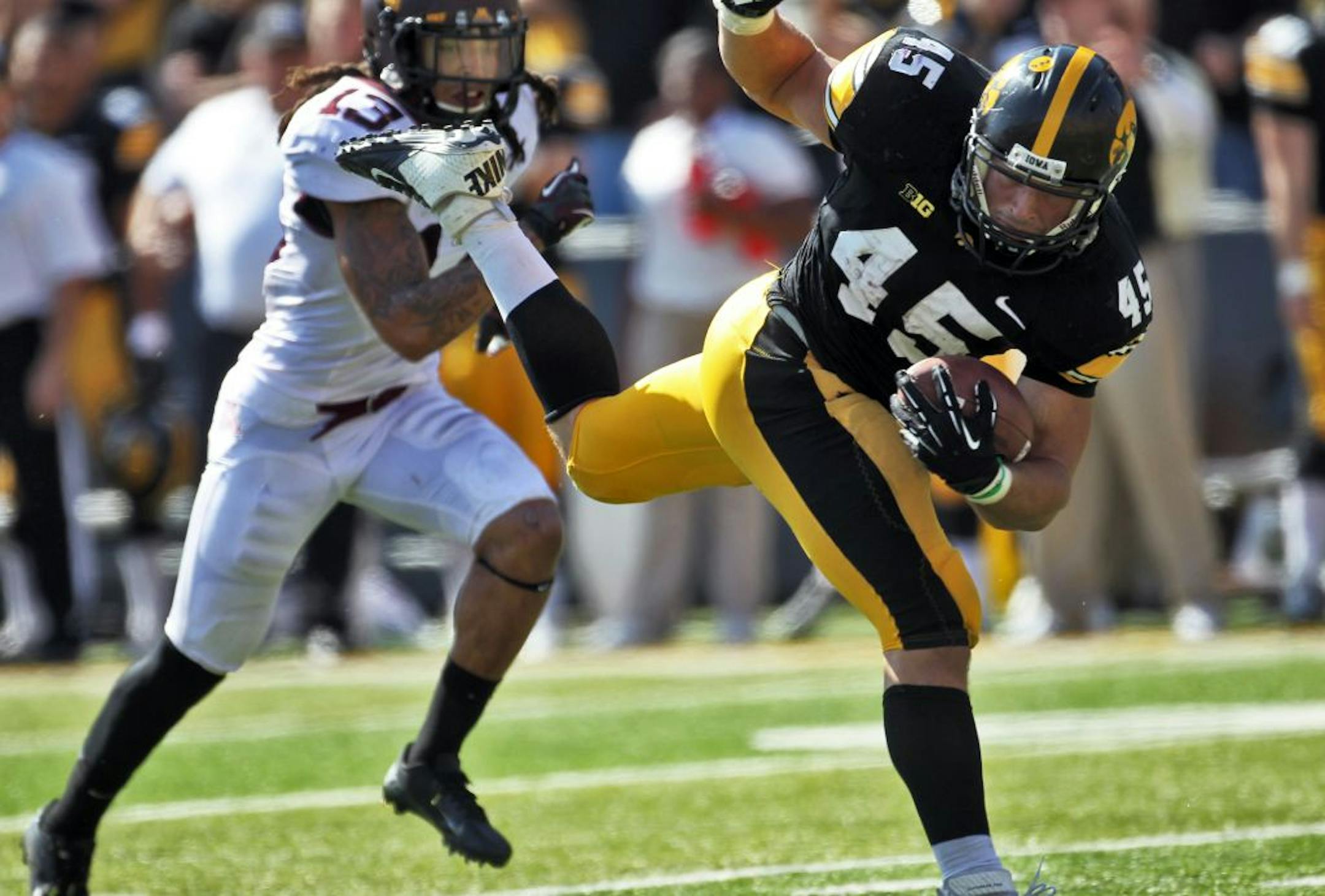 Minnesota Gophers vs. Iowa Hawkeyes football. Iowa won 31-13. Iowa running back Mark Weisman picked up some of his 177 yards rushing in the game, leaving Minnesota tackler Derrick Wells behind on this 2nd-half play. (MARLIN LEVISON/STARTRIBUNE(mlevison@startribune.com