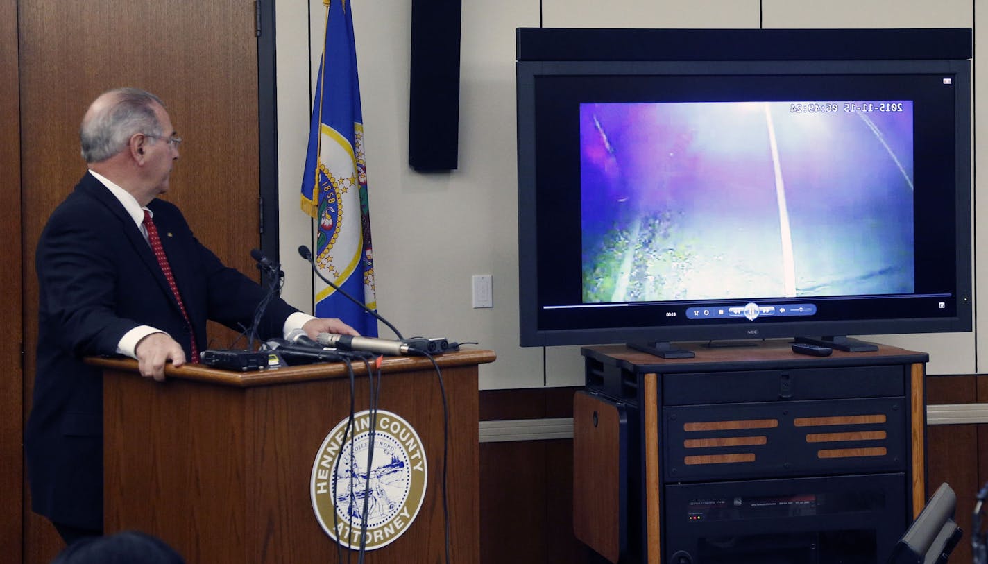 County Attorney Mike Freeman, shows video from evidence after he announced Wednesday, March 30, 2016, that no charges will be filed against two Minneapolis police officers in the fatal shooting of a black man, Jamar Clark, last November in Minneapolis. Community activists in Minneapolis say they don&#xed;t accept the prosecutor&#xed;s decision. (AP Photo/Jim Mone)