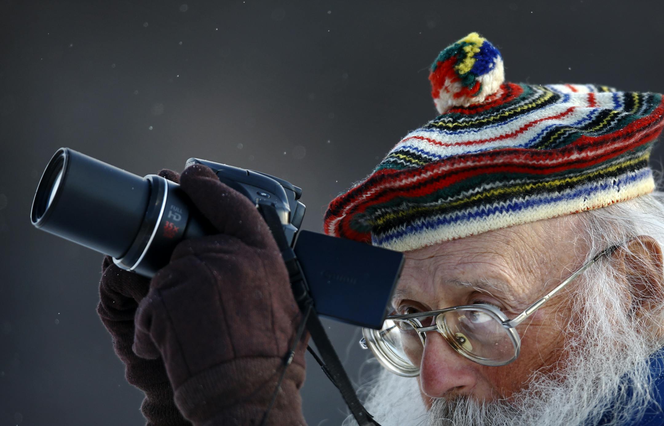 Sidney Crawford of Ozona, FL, aims his digital camera at a rarely seen boreal owl perching on the limb of a dead tree, off of a rural road during the Sax-Zim Winter Birding Festival Saturday, Feb. 16, 2013, at the Sax-Zim Bog in Meadowlands, MN. It was Crawford's fourth trip to the bog, requiring him to fly in on a commercial jet and then rent a car. "I've only been doing it for 60 years," Crawford responded to the question of whether birding was worth it.] (DAVID JOLES/STARTRIBUNE) djoles@start