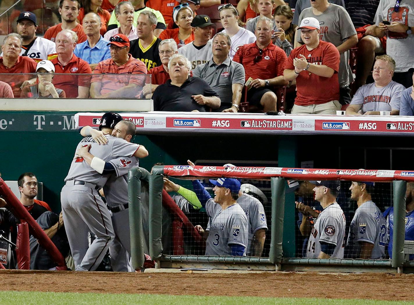 American League's Brian Dozier, of the Minnesota Twins, is hugged by American League's Jason Kipnis,of the Cleveland Indians, after hitting a home run during the eighth inning of the MLB All-Star baseball game, Tuesday, July 14, 2015, in Cincinnati.