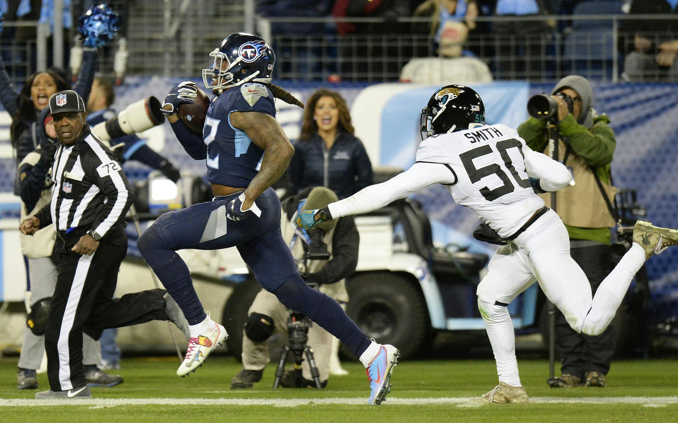 Tennessee Titans running back Derrick Henry (22) runs for a touchdown against Jacksonville Jaguars outside linebacker Telvin Smith (50) during the second half of an NFL football game, Thursday, Dec. 6, 2018, in Nashville, Tenn. (AP Photo/Mark Zaleski)