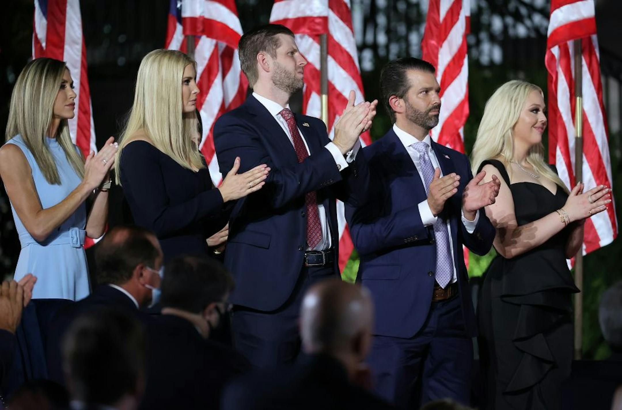 From left, Lara Trump, Ivanka Trump, Eric Trump, Donald Trump Jr. and Tiffany Trump applaud as President Donald Trump delivers his acceptance speech for the Republican presidential nomination on the South Lawn of the White House on Thursday, Aug. 27, 2020, in Washington, D.C.