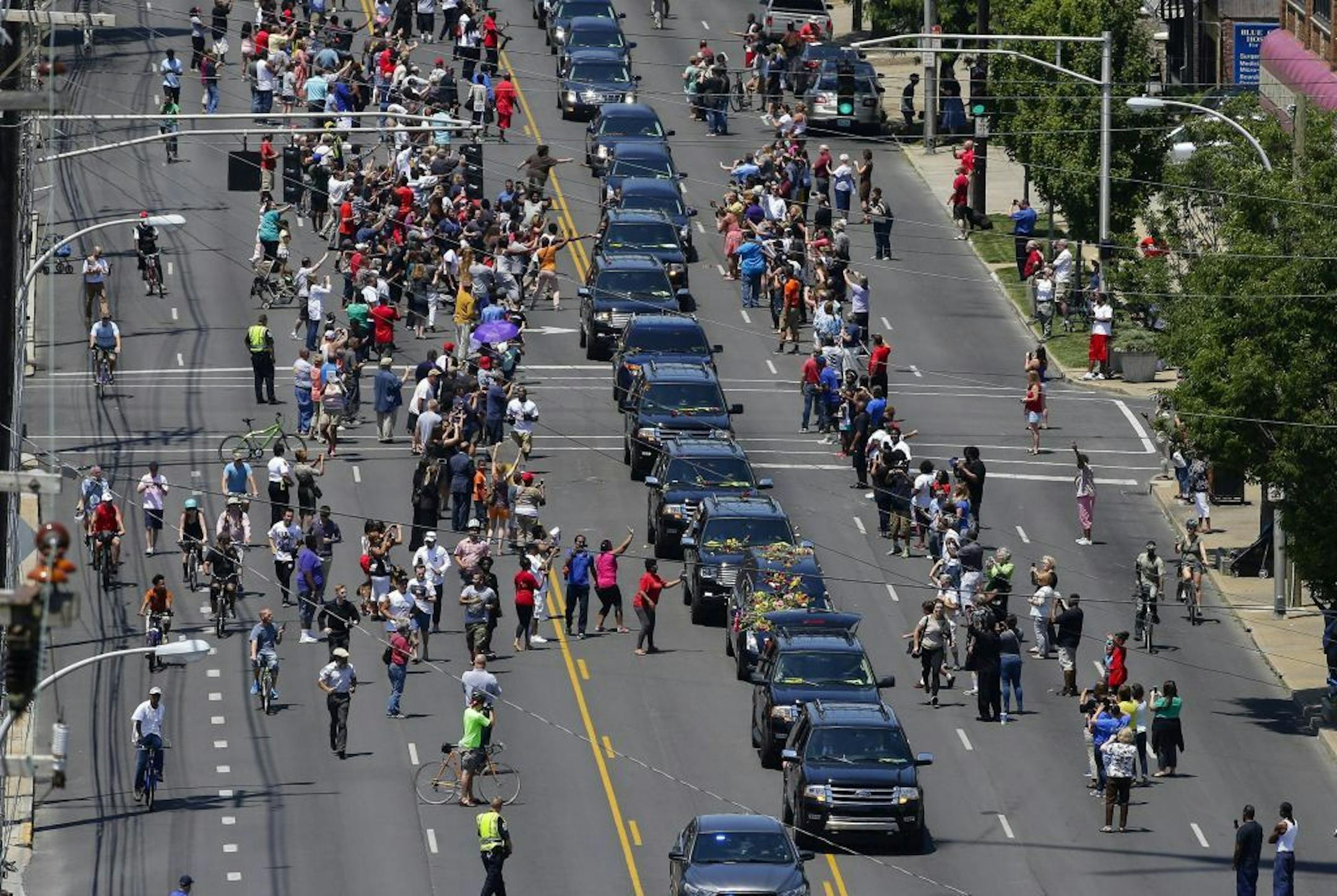 The funeral procession for Muhammad Ali makes its way along Broadway to his burial in Cave Hill Cemetery, in downtown Louisville, Ky., on Friday, June 10, 2016. Ali, a three-time world heavyweight champion, died June 3, 2016, at 74.