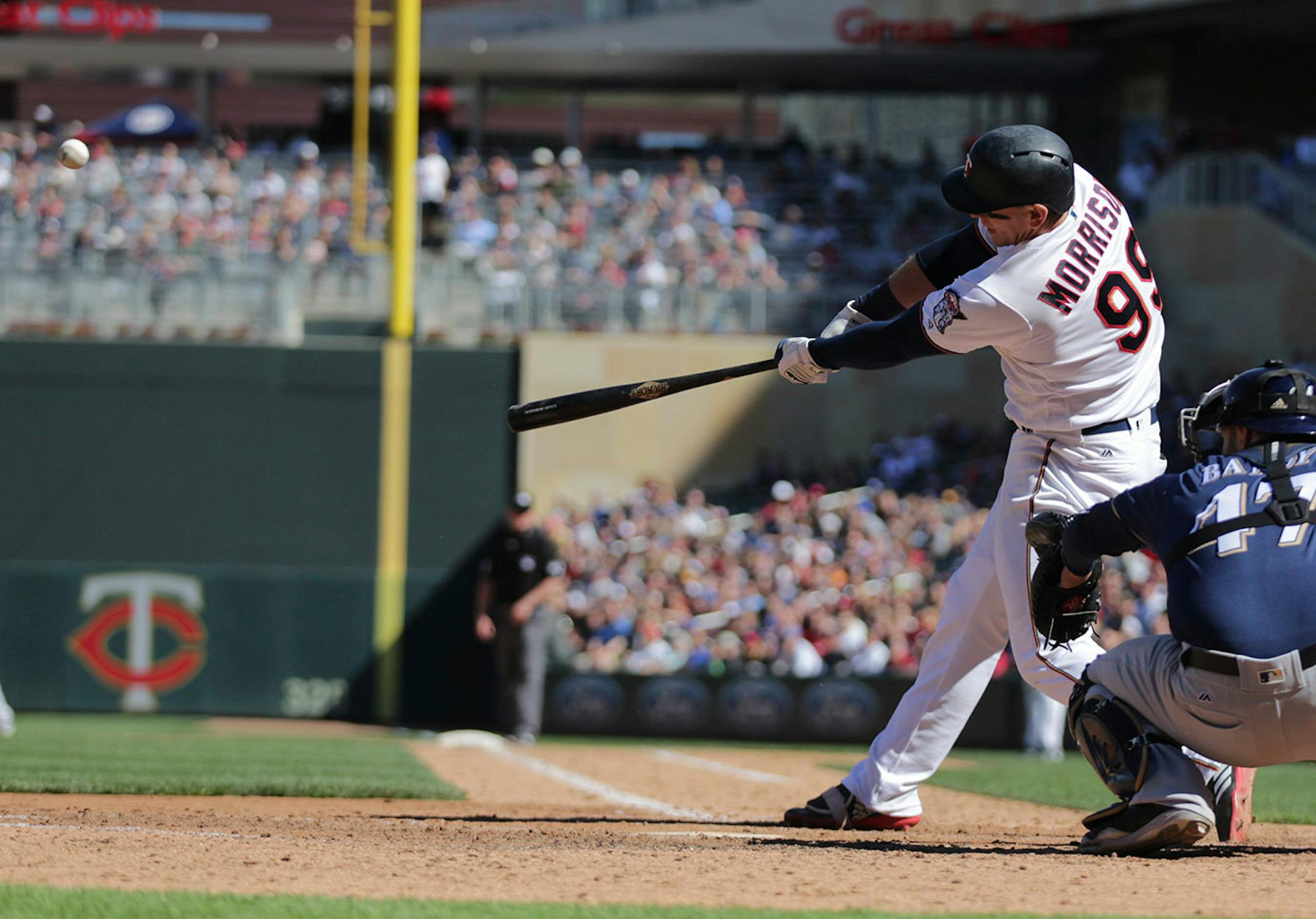 Minnesota Twins first baseman Logan Morrison (99) hits a two-run RBI against the Milwaukee Brewers in the eighth inning of a baseball game Sunday, May 20, 2018, in Minneapolis. The Twins defeated the Brewers 3-1. (AP Photo/Andy Clayton-King)