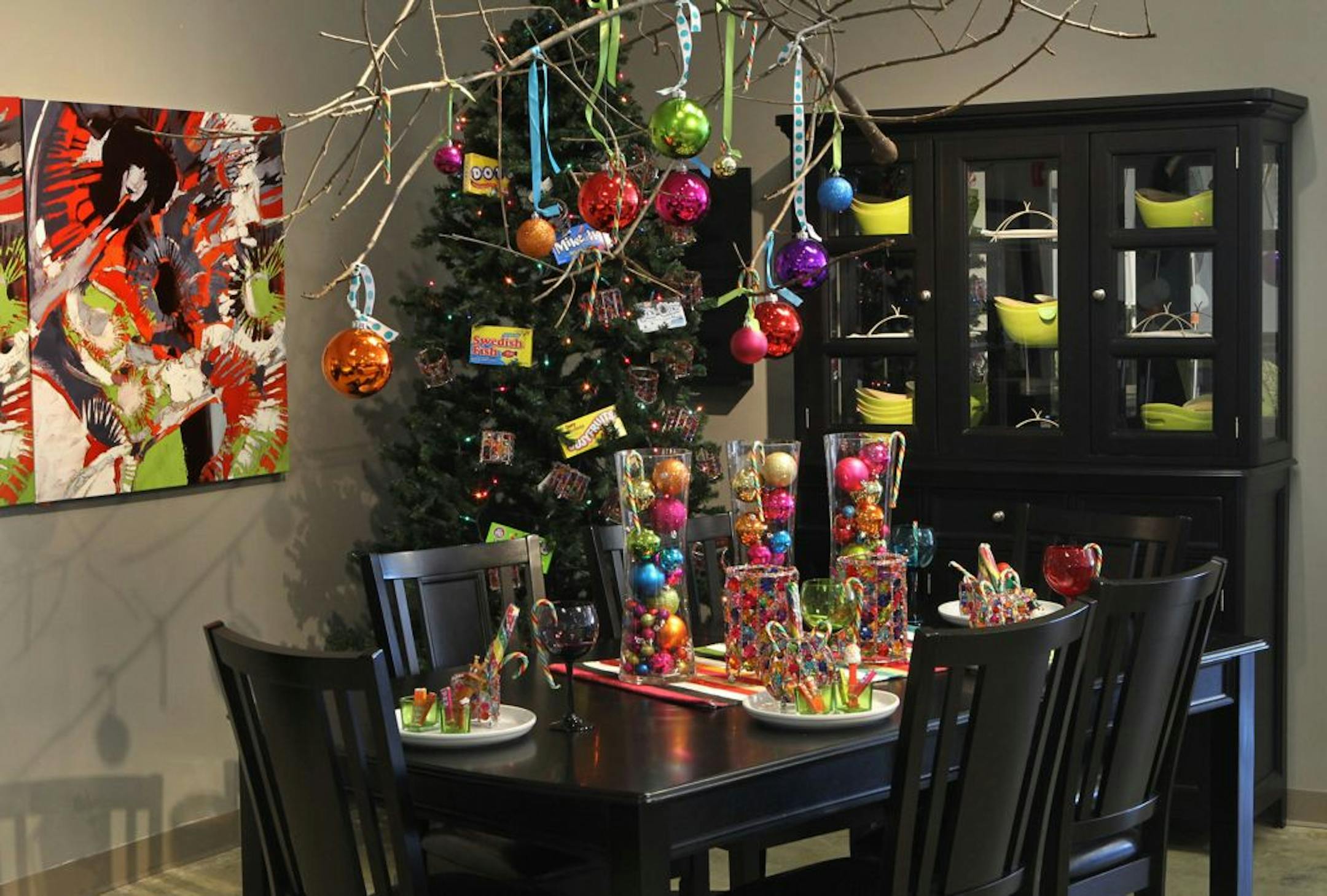 The designers at Ashley Furniture in Ballwin, Missouri set up several holiday decor scenes in their showroom on Manchester Road, November 13, 2012. A second colorful dining room display utilizes holiday ornaments for a hanging display and a table centerpiece.
