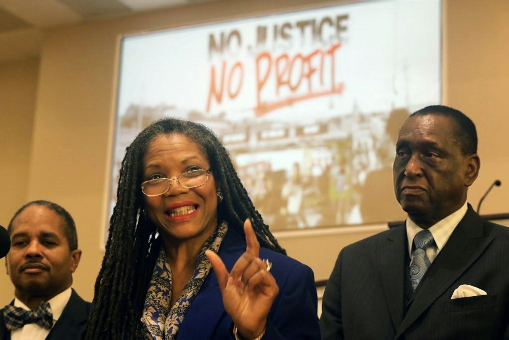 The Rev. Dinah Tatman, center, with Greater New Vision Ministries, Inc., announces details of a new economic boycott as Rev. Ronald Bobo, left, pastor of West Side Missionary Baptist Church and Minister Donald Muhammad, look on Thursday, Nov. 2, 2017 in St. Louis, Mo. Tatman said African-Americans are subjected to excessive force by police, criminalized for minor infractions and saddled with long sentences. She also cited economic disparities, efforts to diminish voting rights and political redi