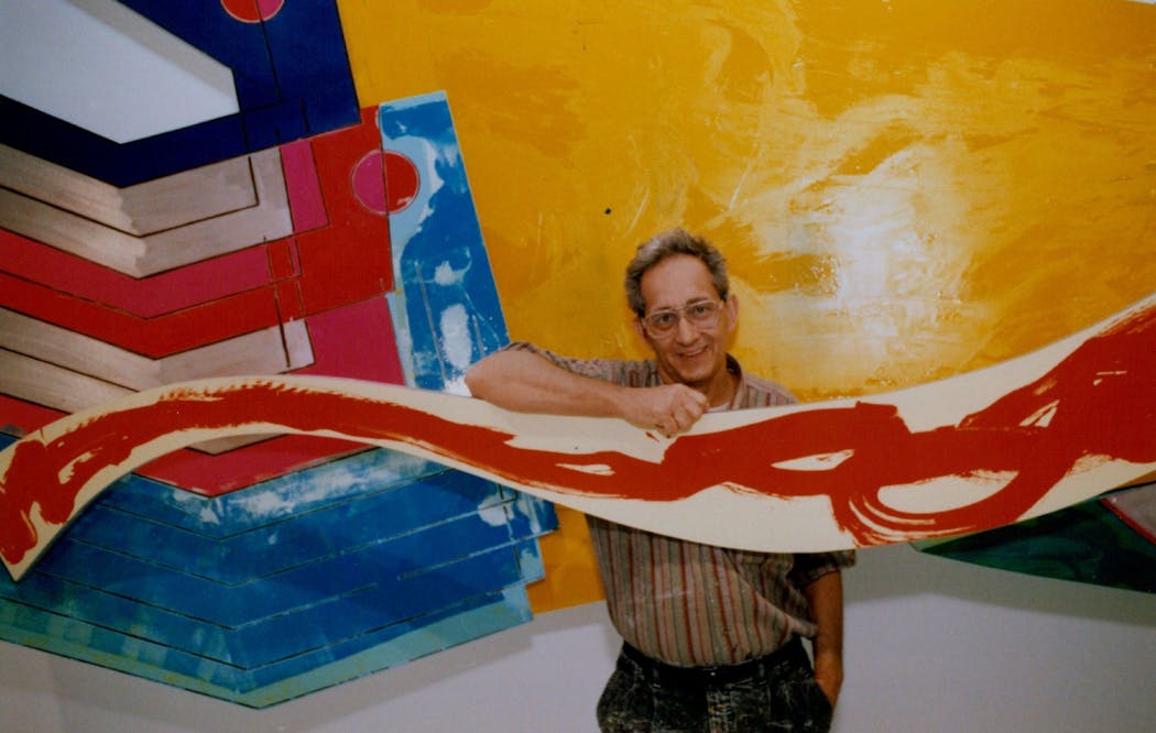 In 1988, artist Frank Stella stands in front of dimensional paintings that were being installed at the Walker Art Center as a part of a major retrospective of Stella's work. 